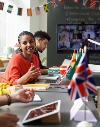 Vertical image of students sitting at international meeting in the classroom and talking to each other